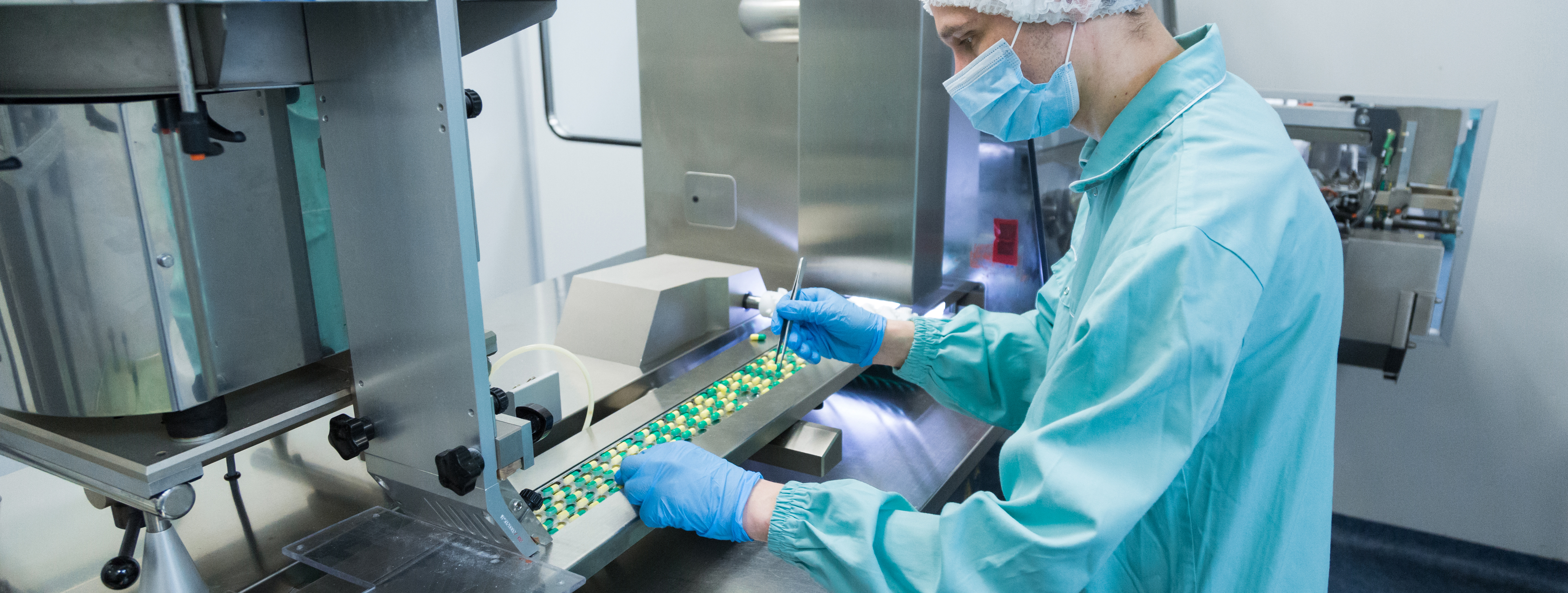 pharmaceutical-industry-man-worker-protective-clothing-operating-production-tablets-sterile-working-conditions.jpg